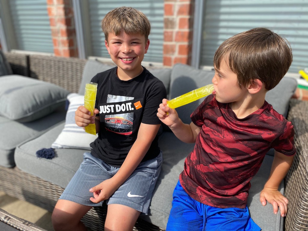 two boys eating pickle juice pops 