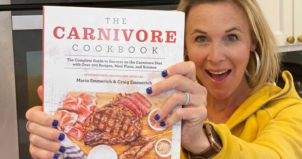woman holding carnivore cookbook