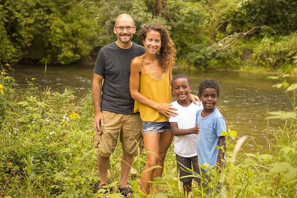 family standing by lake