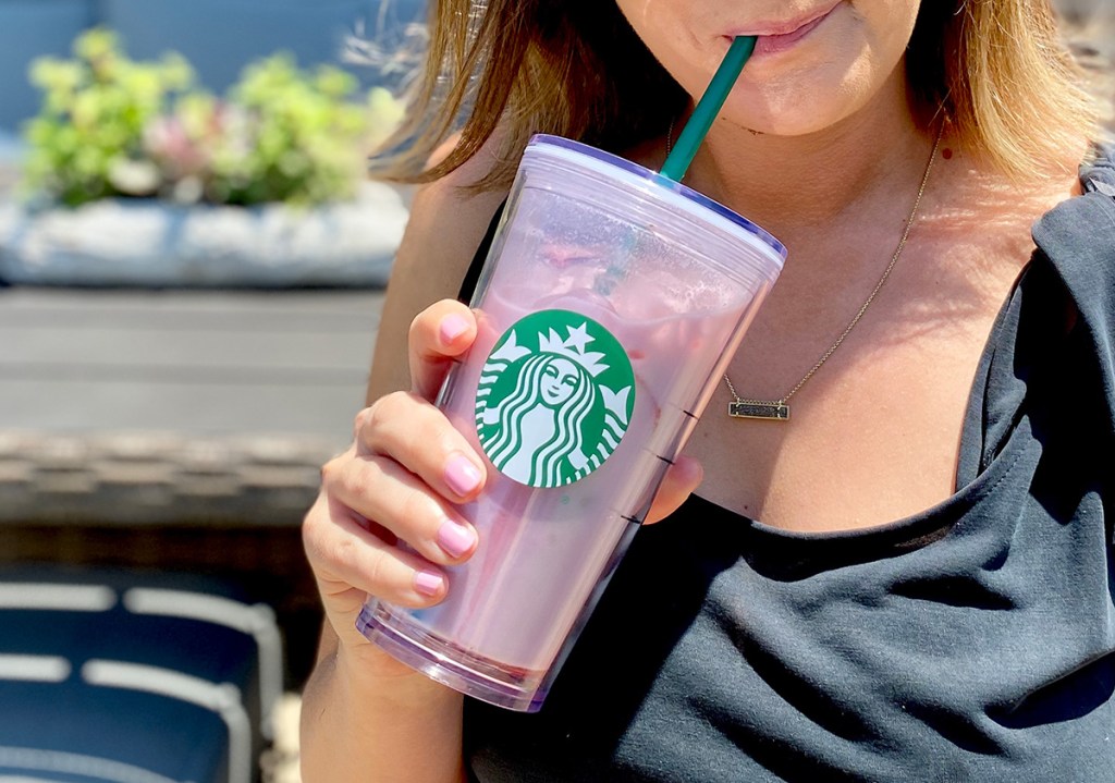 sipping keto pink drink from starbucks cup