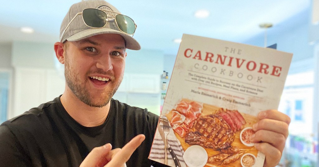 man holding carnivore cookbook