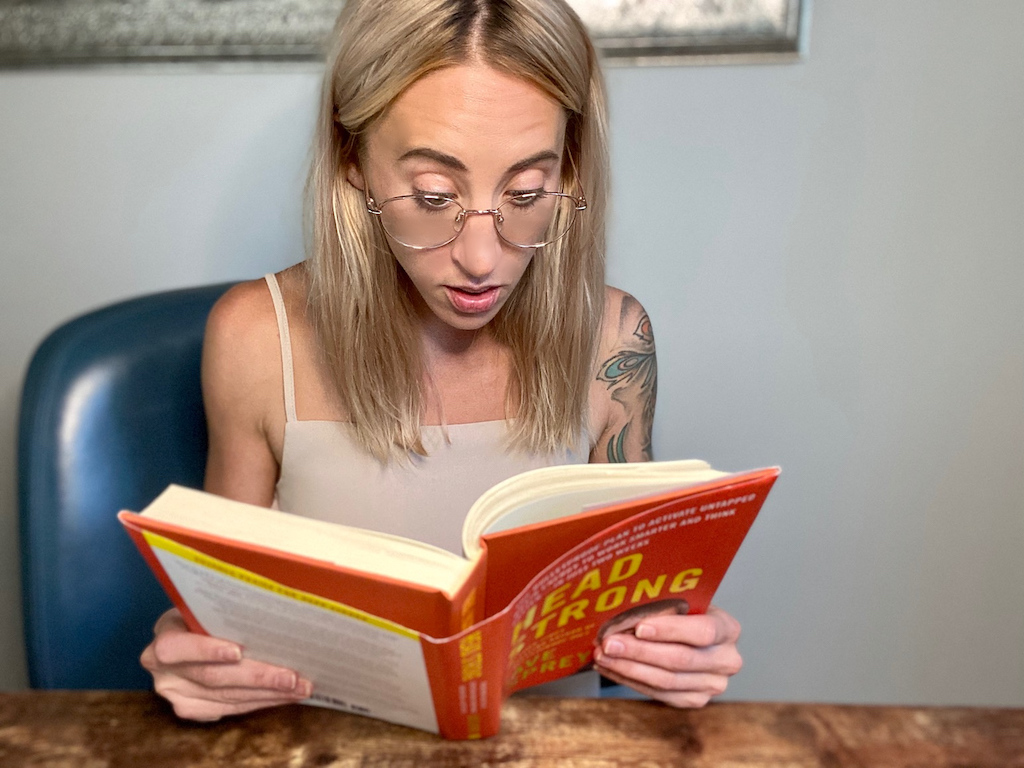 woman reading first chapter of Head Strong book 