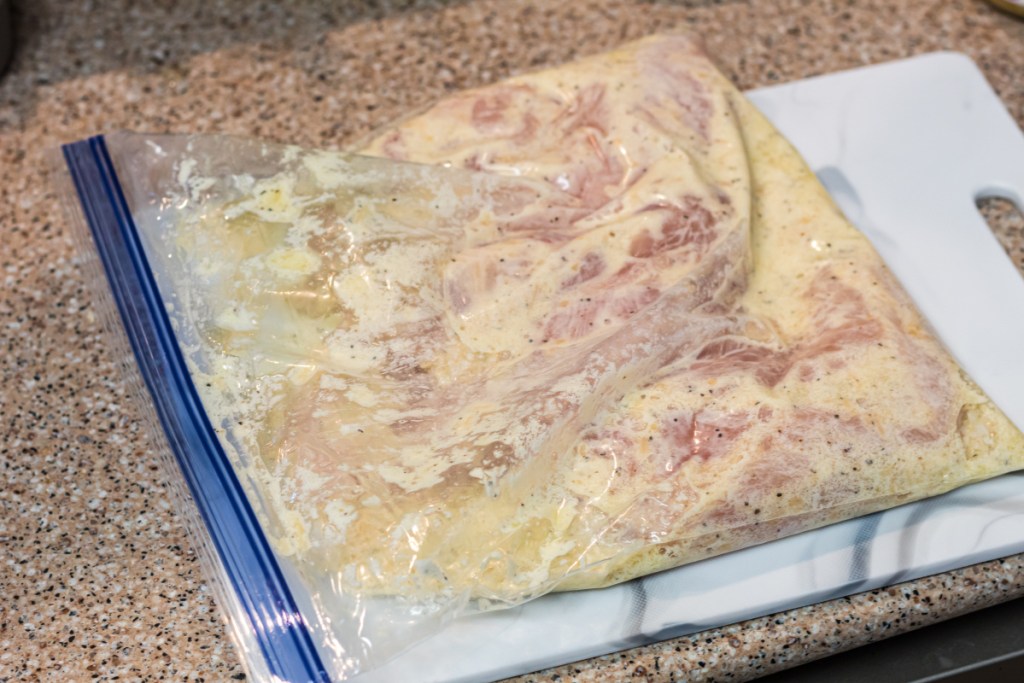 chicken in a zip lock bag marinating 