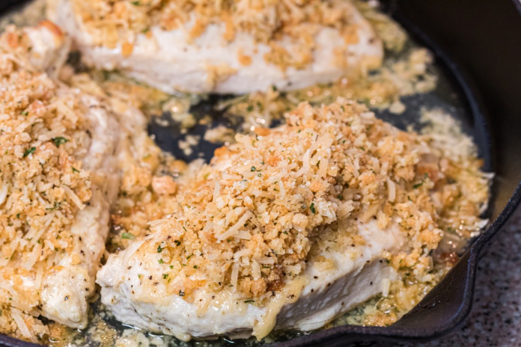 topping chicken with breadcrumbs