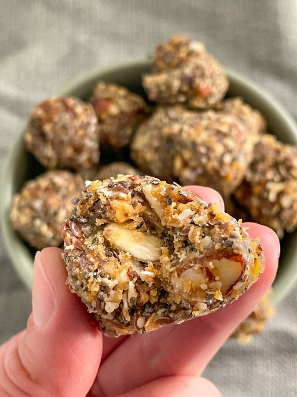 holding keto protein ball with a bite out of it