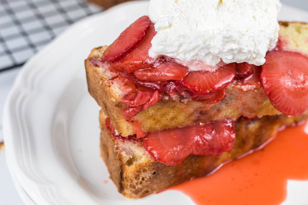 keto strawberry shortcake topped with fresh strawberries and whipped cream