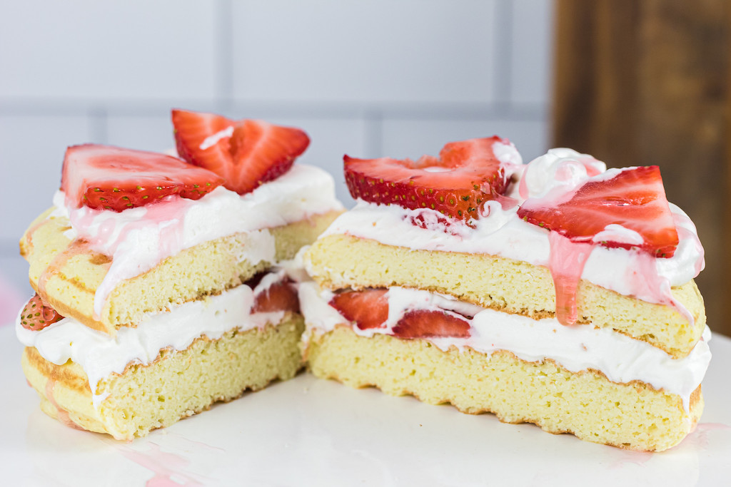 keto strawberry shortcake chaffle sliced in half 