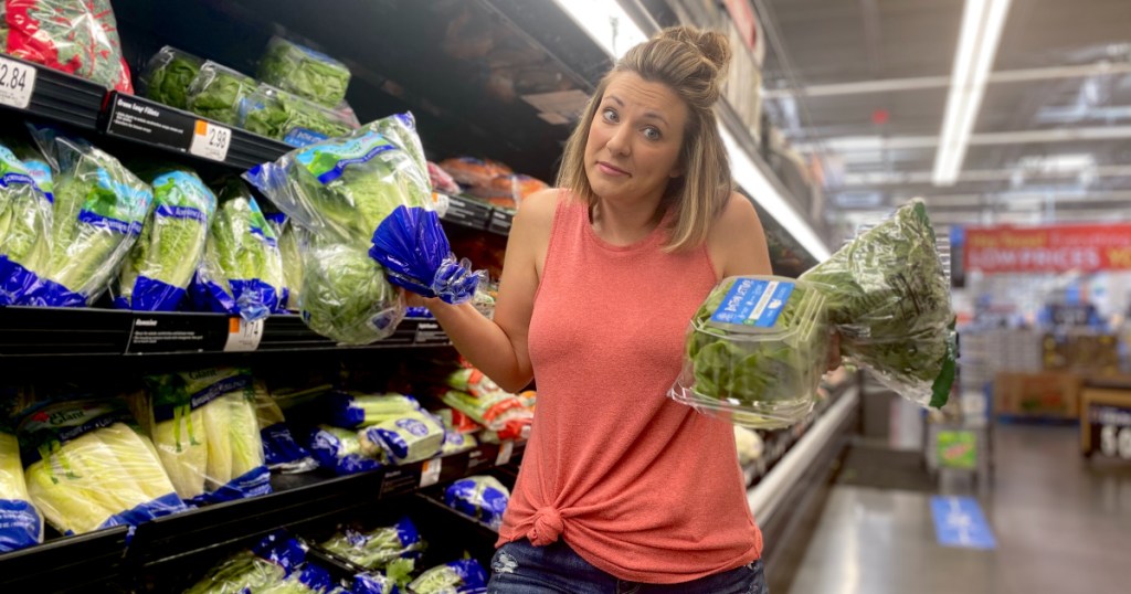 girl holding different types of lettuce