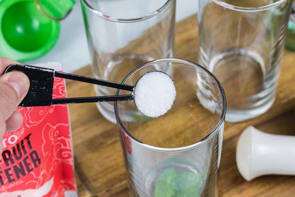 adding in monk fruit sweetener into glass