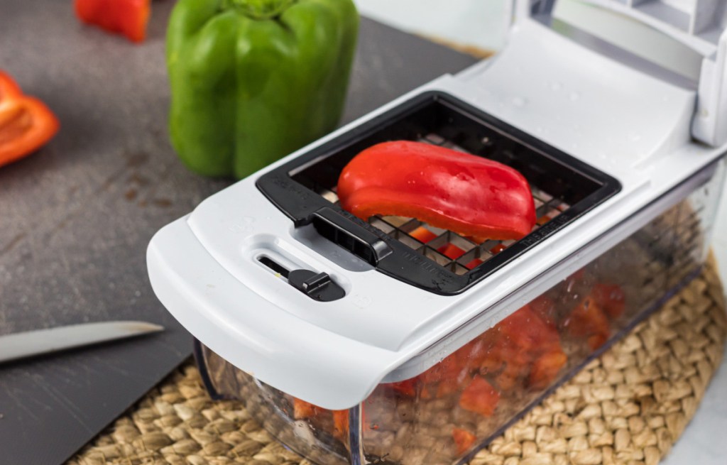 using a vegetable chopper to dice a red bell pepper