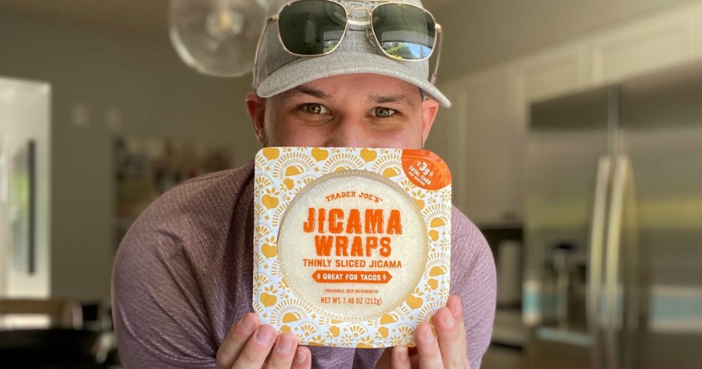 man holding Trader Joe's jicama wraps 