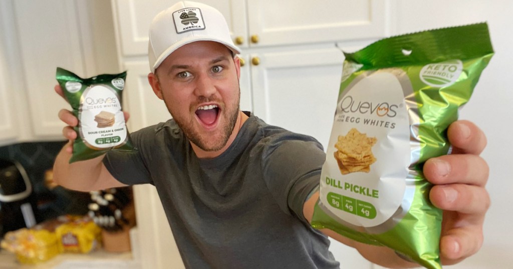 man holding quevos chips