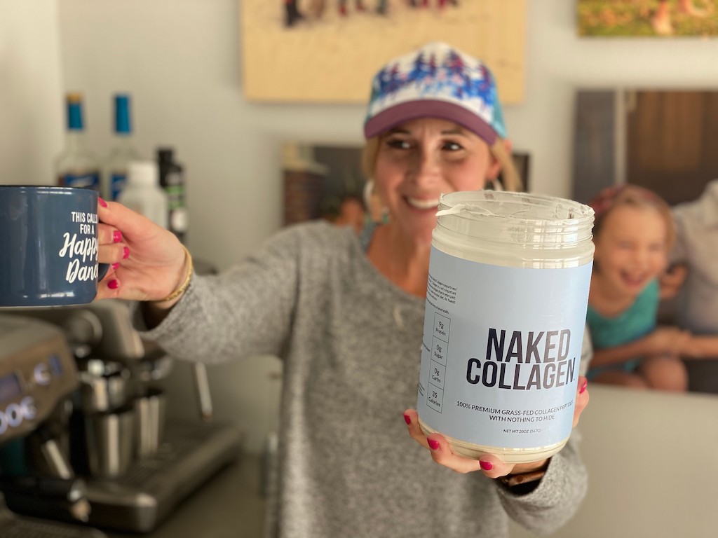 woman holding Naked Collagen tub and coffee cup 