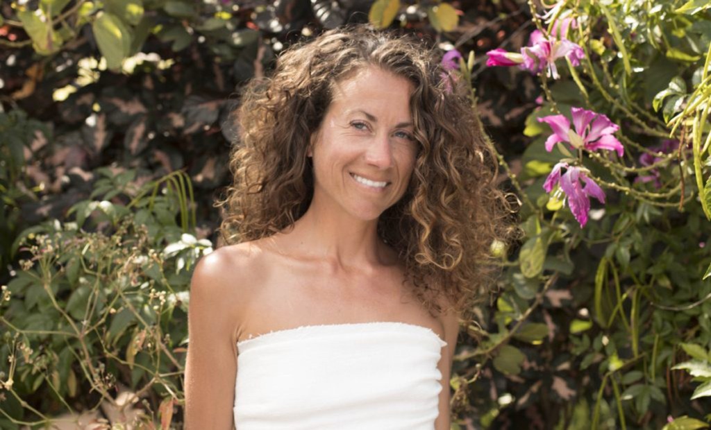 woman standing in front of greenery