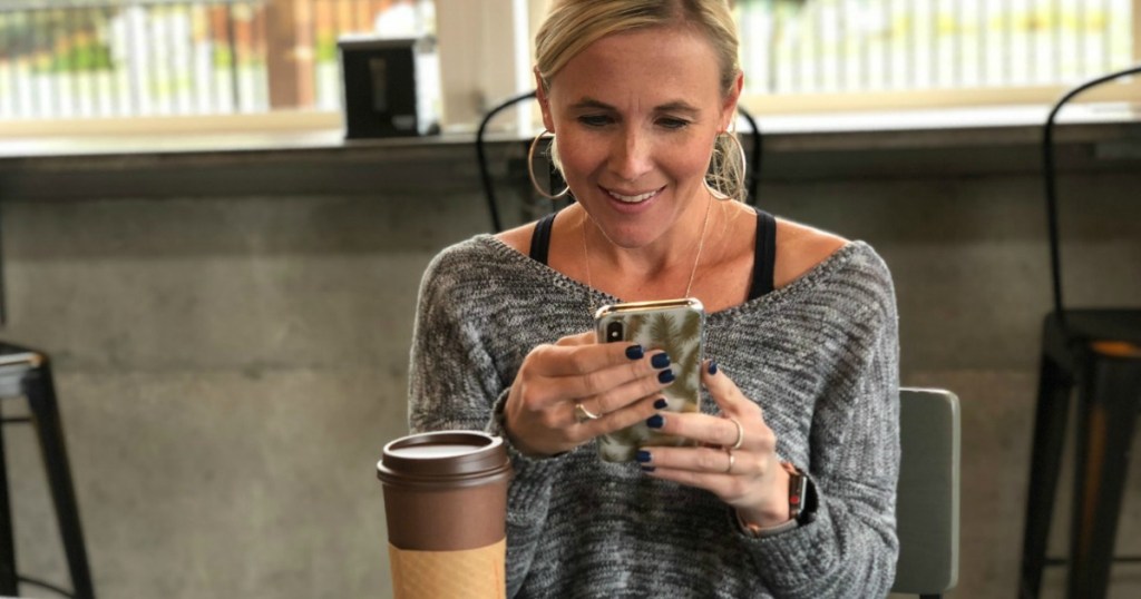 woman text messaging in coffee shop 