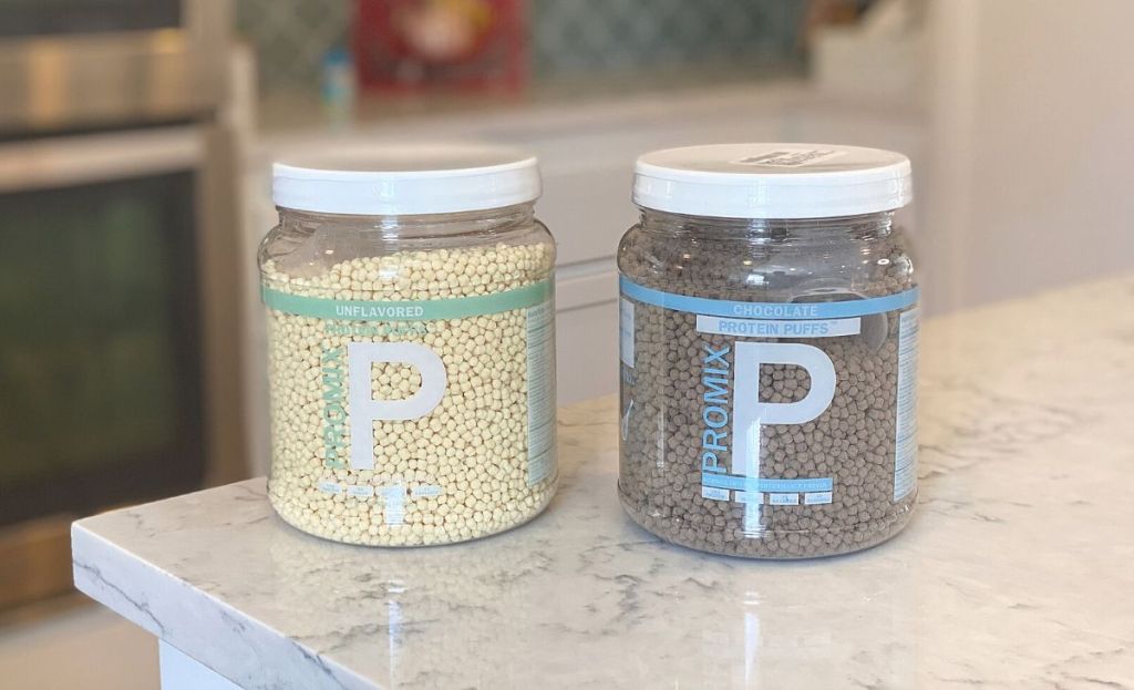 2 containers of Promix protein puffs on a counter