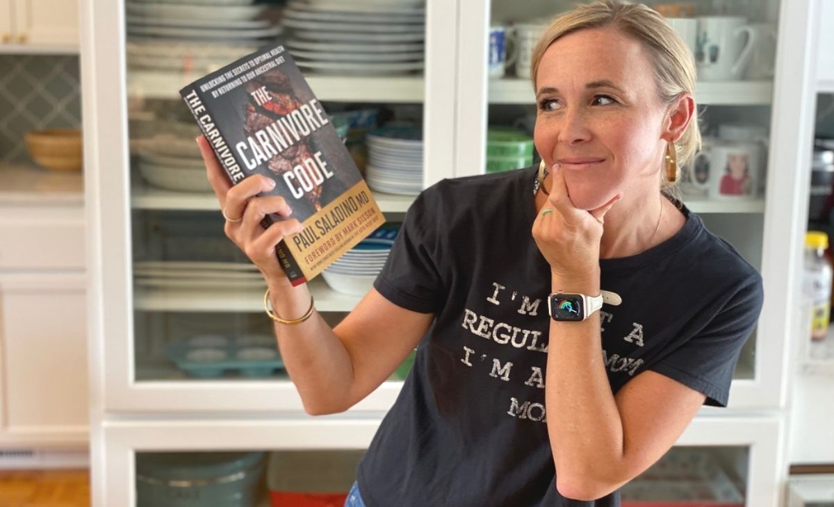 A woman holding a book and looking at it