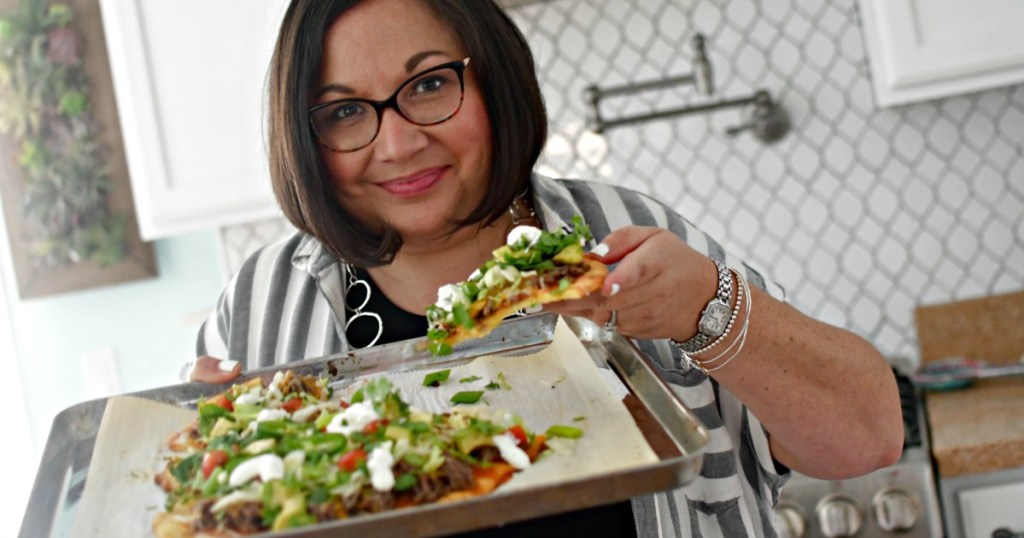 woman holding keto taco pizza