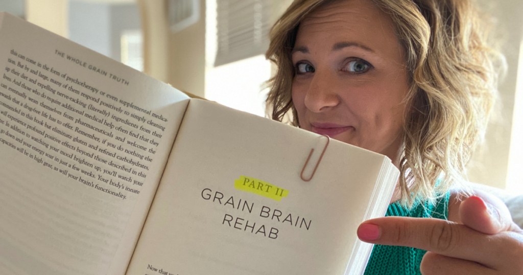 Girl holding Grain Brain book