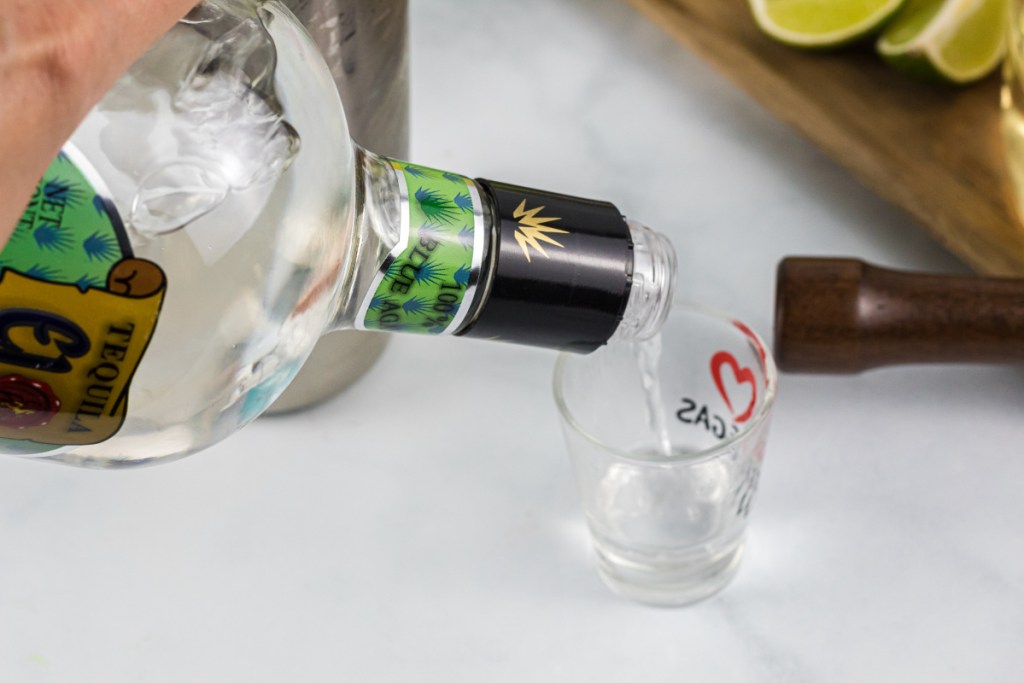 pouring tequila into shot glass
