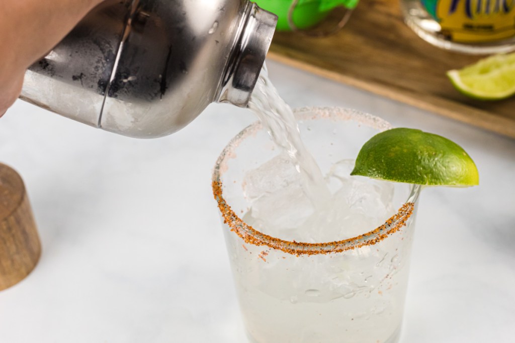 pouring margarita in glass