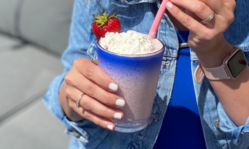 hand holding a low carb strawberry banana smoothie that is keto