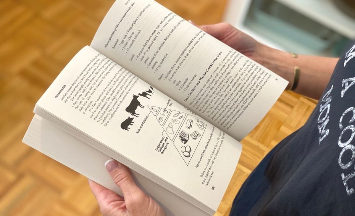Someone holding a book open to a page 