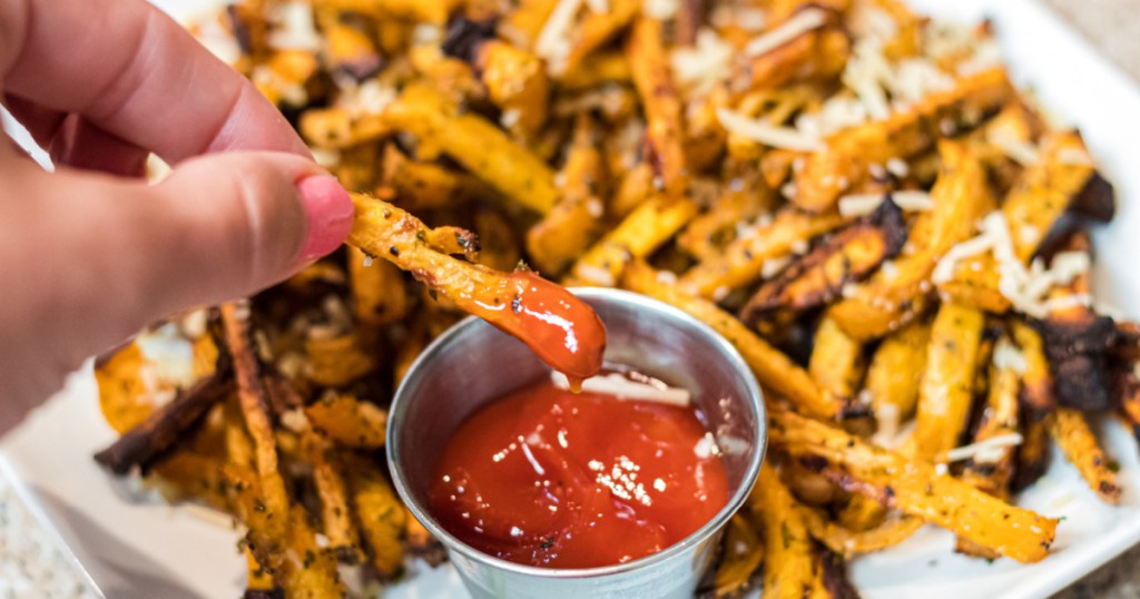 dipping rutabaga fries into keto ketchup