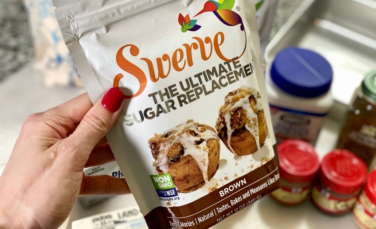 A hand holding a bag of Swerve Brown sweetener