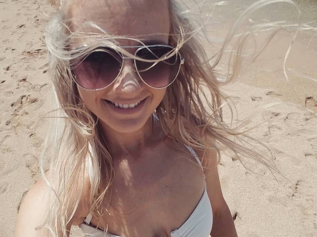 woman in white bikini and sunglasses on beach