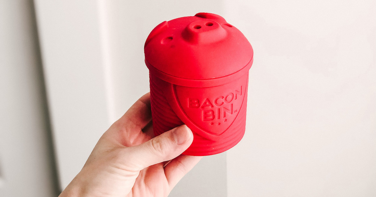 hand holding a red bacon bin 