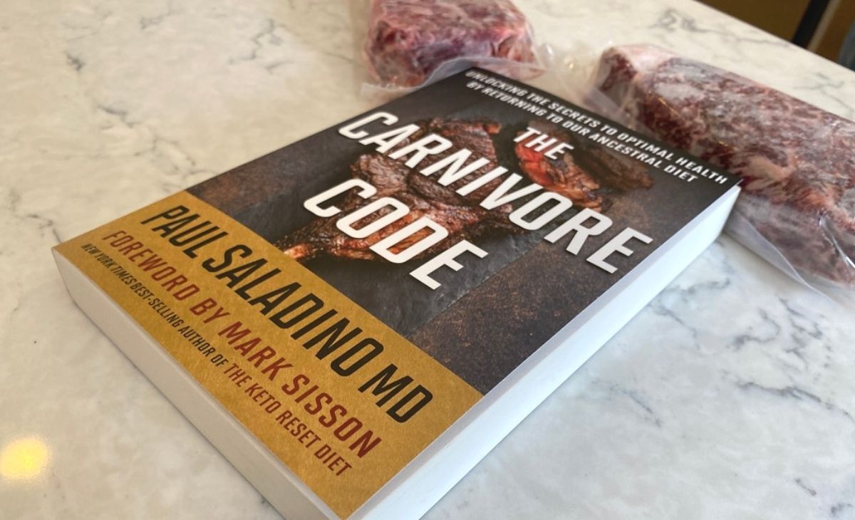 A book on a counter next to steak