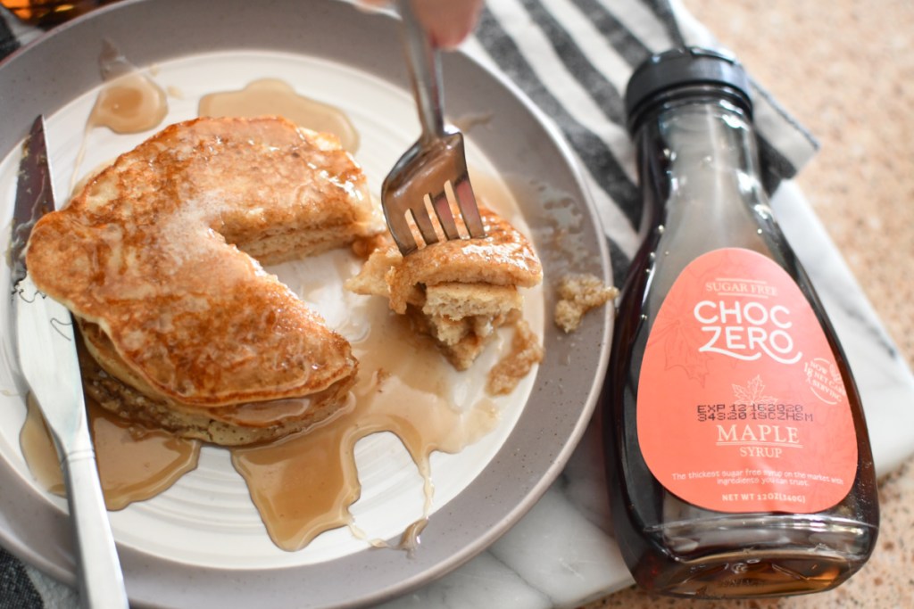 Choczero maple syrup beside stack of pancakes