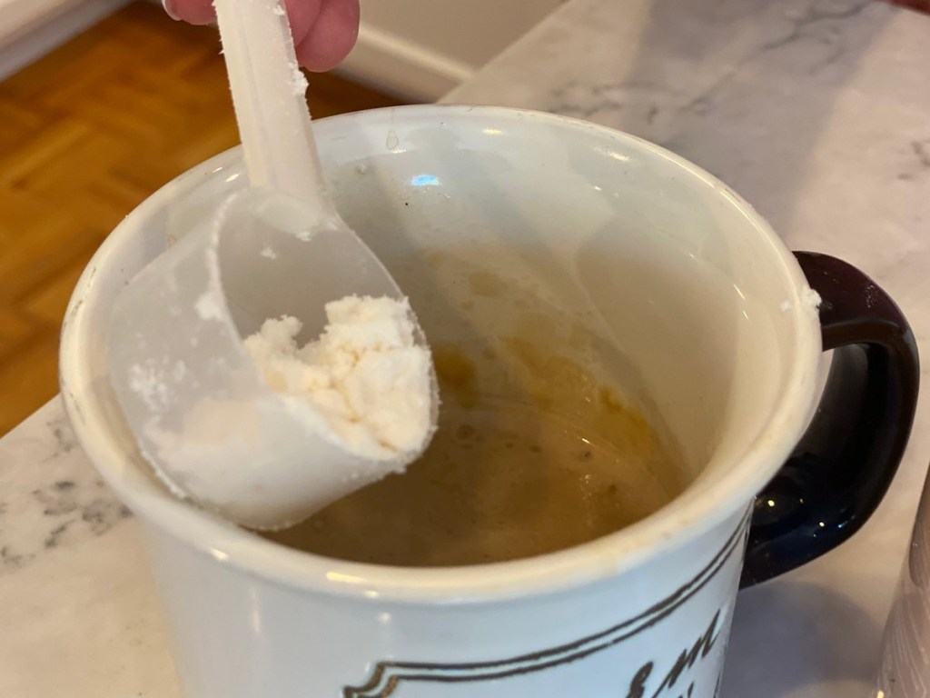 powdered creamer going into coffee mug