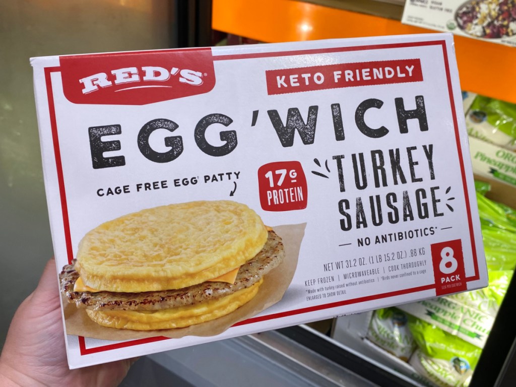 hand holding package of frozen breakfast sandwiches in store