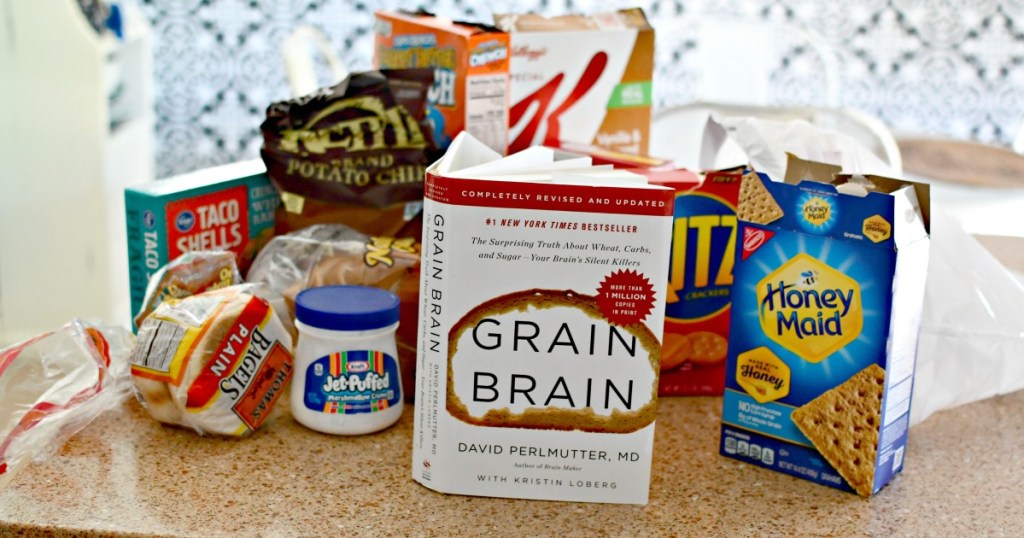 grain brain book surrounded by highly processed foods