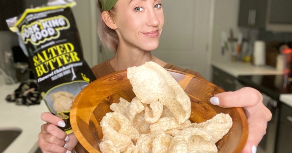 holding bowl of pork rinds 