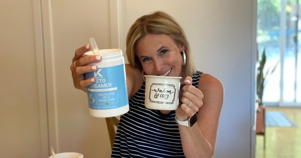 woman holding coffee mug and canister of powdered creamer