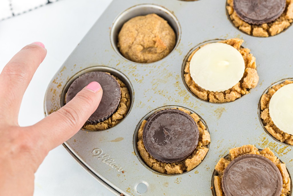 pressing peanut butter cup into cookie