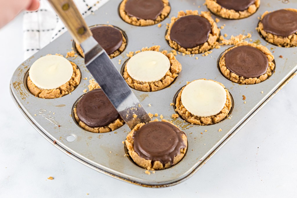 lifting out peanut butter cup cookie from pan