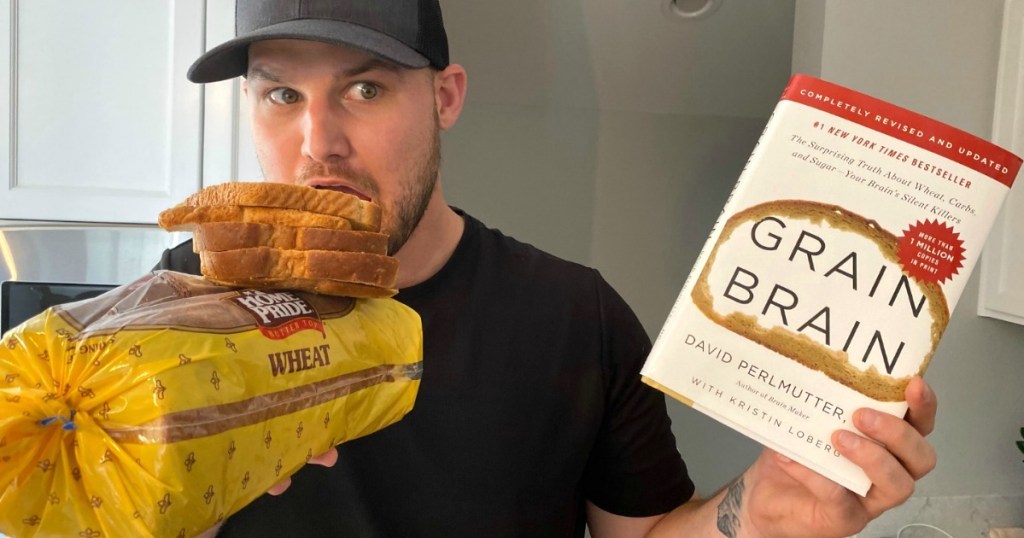 man holding loaf of bread and Grain Brain book 