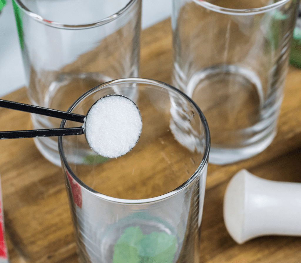 putting teaspoon of monk fruit in glass 