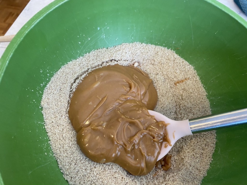 SunFlour and peanut butter being stirred in green bowl
