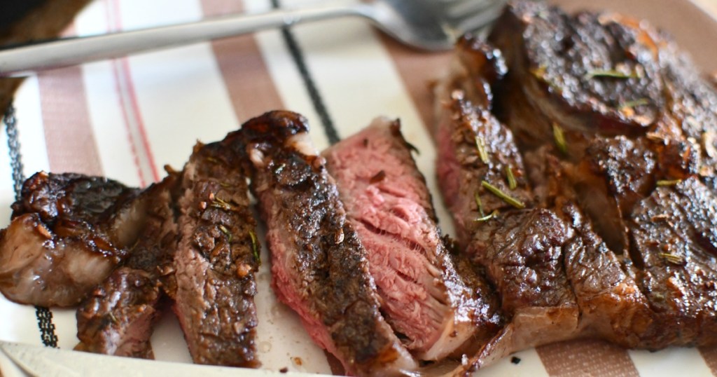 plate with a cut up air fryer steak on top