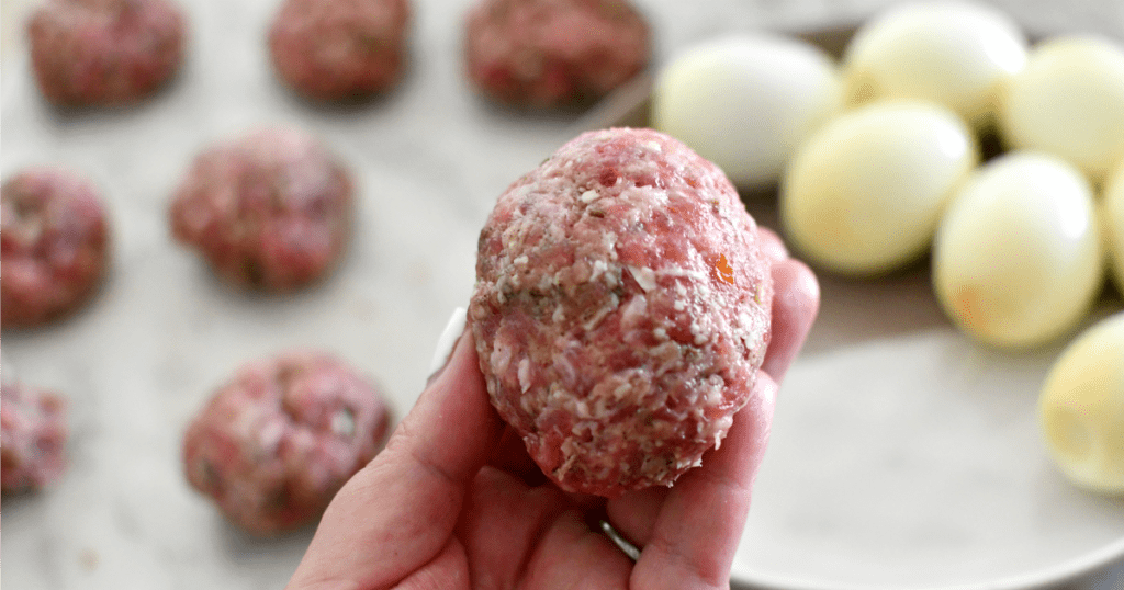 raw sausage covered eggs