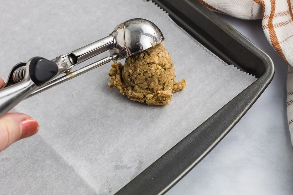scooping oatmeal cookies on pan