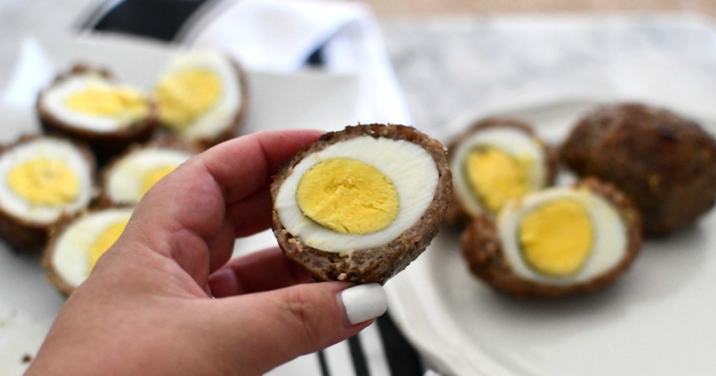 holding opened scotch egg 