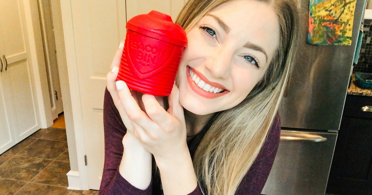 woman smiling while holding red bacon bin