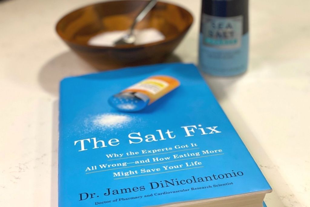 The Salt Fix hardcover on a counter next to some salt