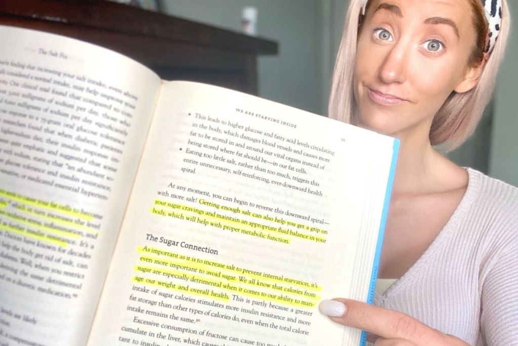 A woman pointing to highlighted text in a book